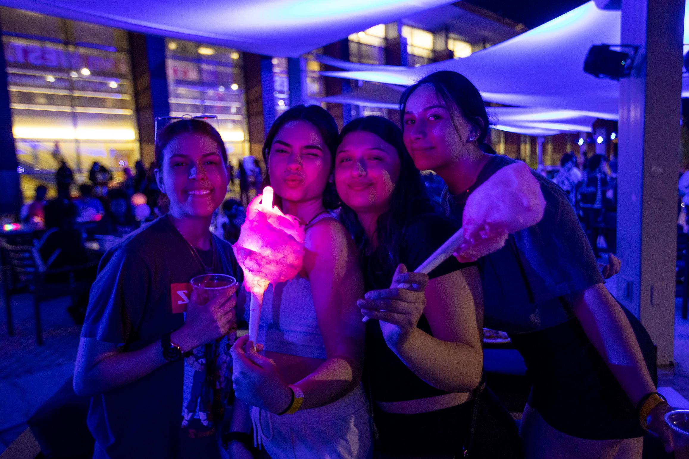 Students eating cotton candy at an event